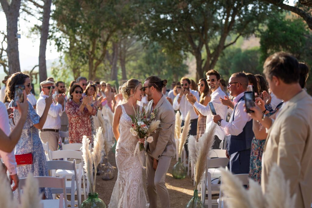 Joyful wedding ceremony exit captured with a documentary approach during a luxury destination wedding.