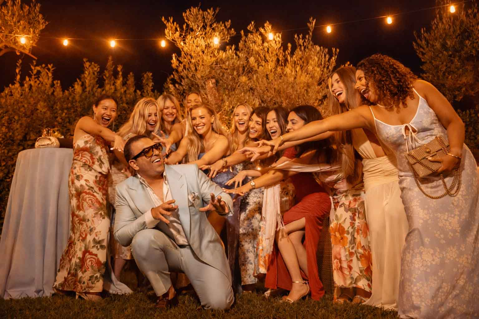 Luxury wedding reception in Dubai with groom and bridesmaids celebrating at sunset