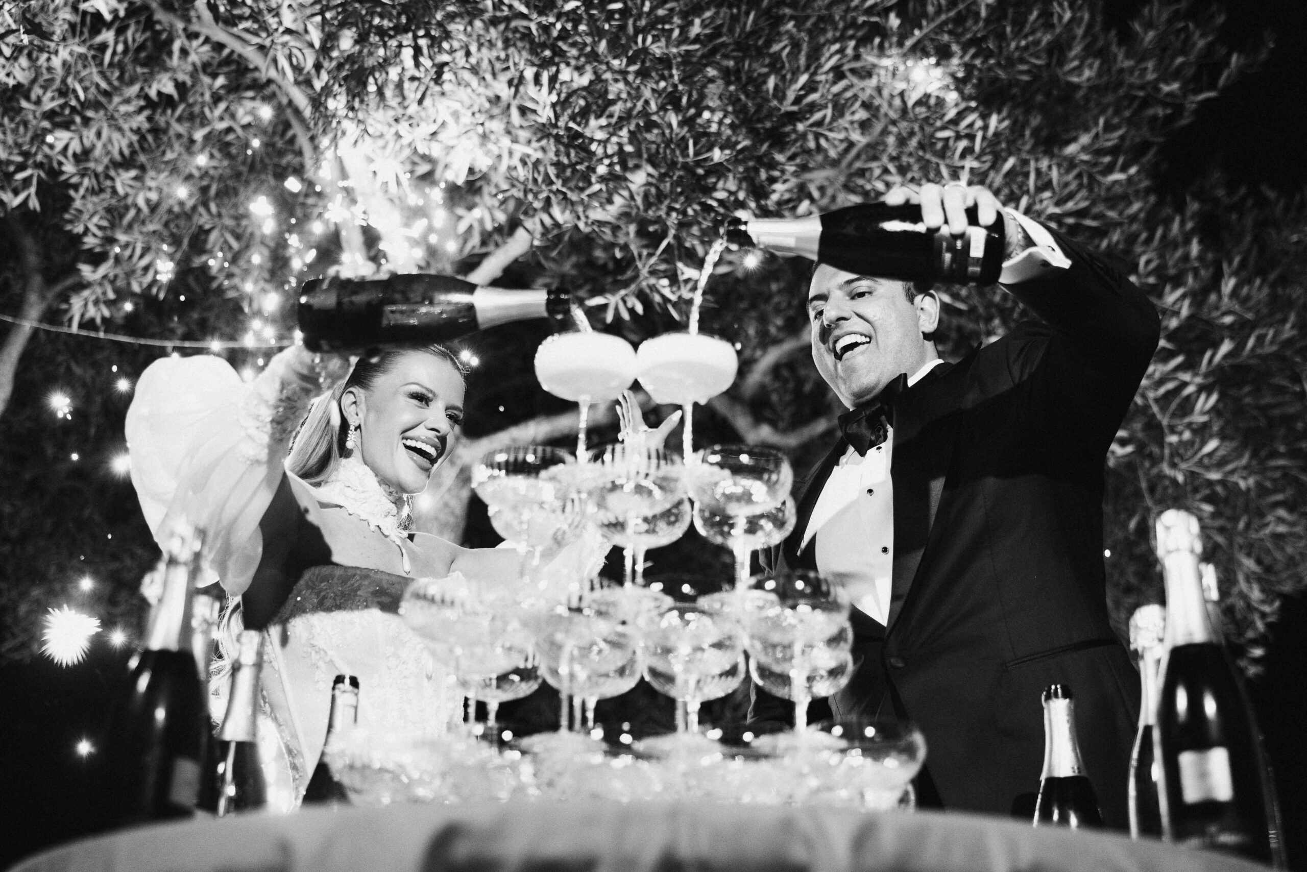 Champagne celebration at a luxury wedding in Dubai captured in black and white