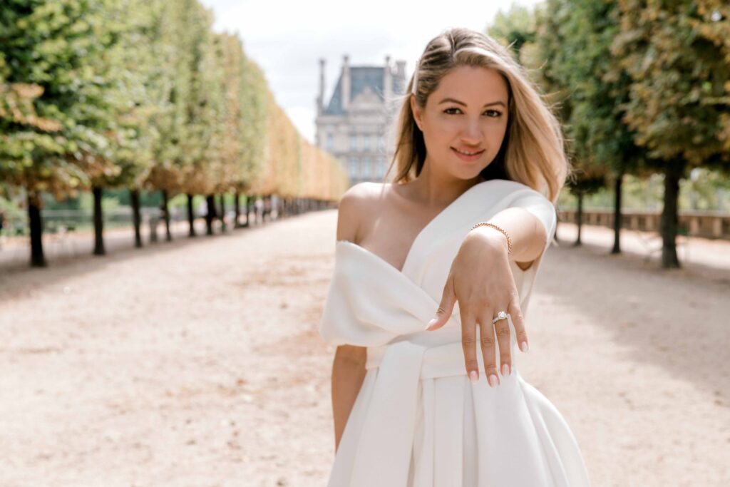 Engagement portrait of a woman showing her ring after a proposal