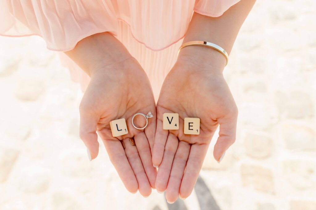 Hands holding love letters and engagement ring during a proposal