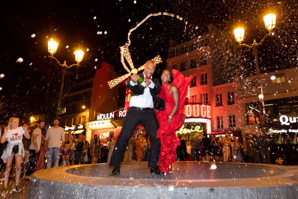 Couple celebrating after a public proposal at night